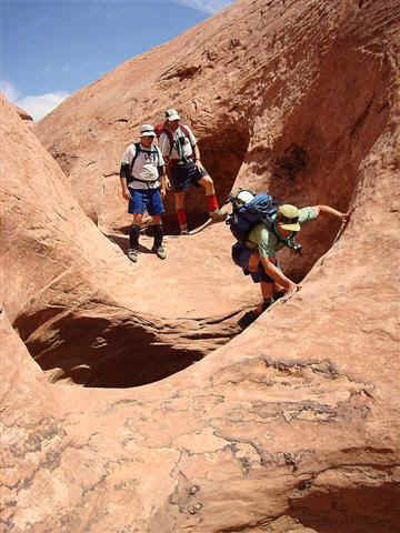 Vince making a big jump across a pothole with Tom & Mark watching.