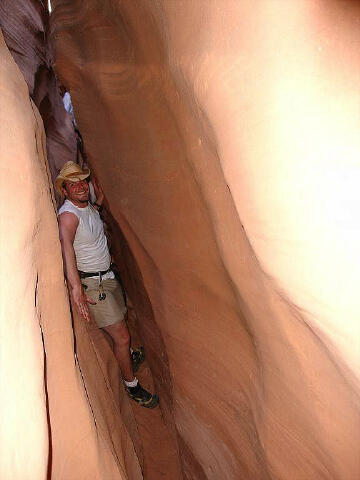 Aaron squeezing through the North Fork of Lost Spring Canyon