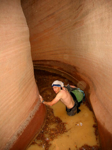 Tom wading through the slot.